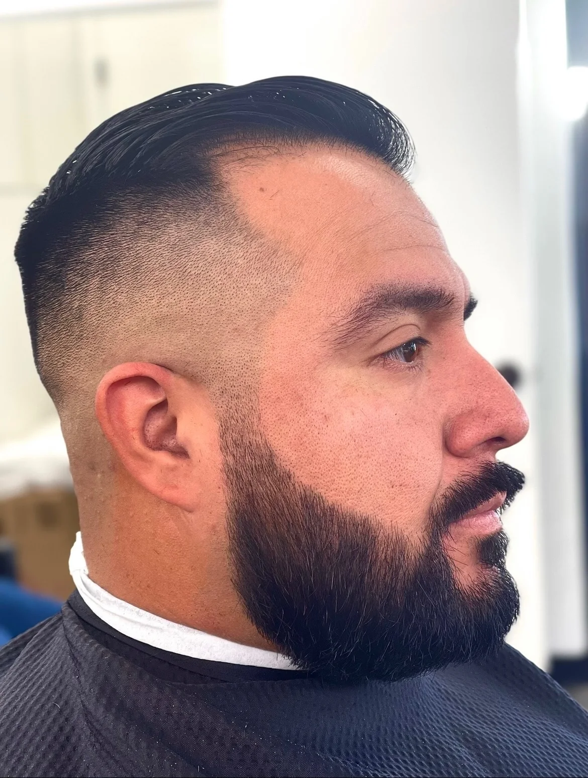Beard shaping with a clean haircut and taper at Masters Barber Co.
