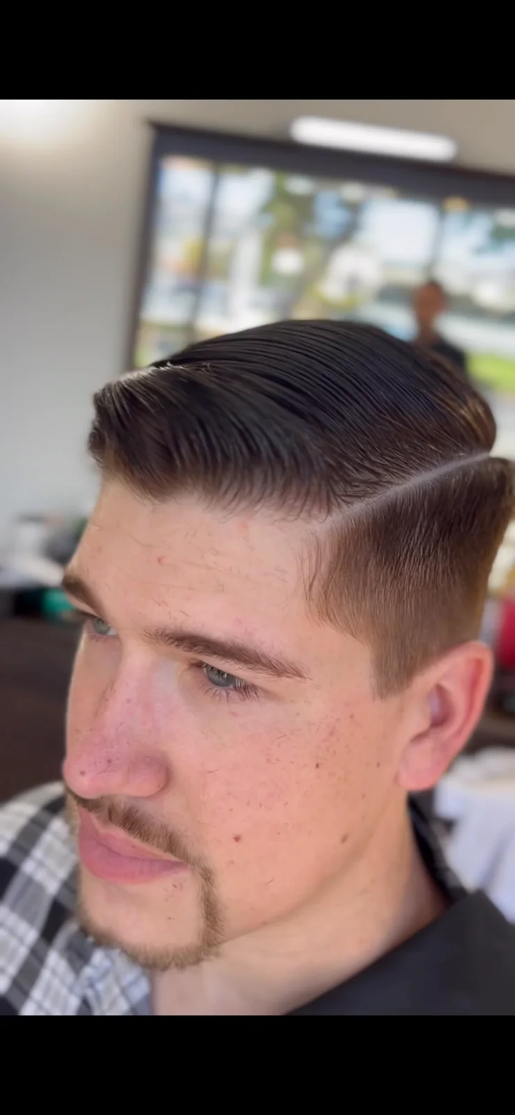 Classic side-part haircut with a clean taper at Masters Barber Co.